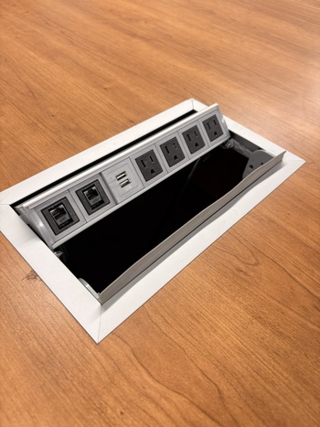 Photo of conference-table-with-for-executive-chairs gallery image 1. Tabletop power module. Details at Oburo, your expert in office, medical clinic and classroom furniture in Montreal.